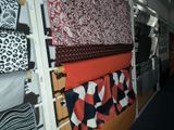 a lot of different fabrics hanging on a wall