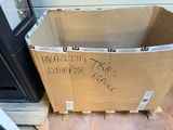 a cardboard box with writing on it sitting on a pallet