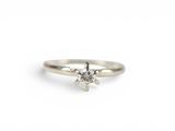 a white gold engagement ring with a single diamond