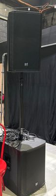 a red chair sitting in front of a speaker system