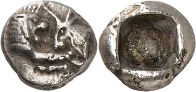 a close up of a coin with a face on it