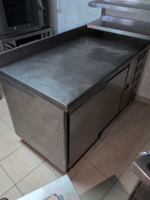 a stainless steel counter top in a kitchen with a stove