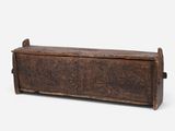an old wooden trunk with carvings on the sides of it