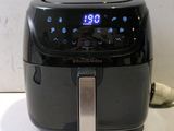 a black air fryer sitting on a counter top