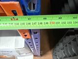 a measuring tape on the floor next to a pair of shoes