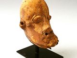 an image of a sculpture of a head on a stand