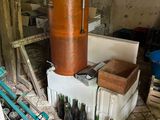 a large copper pot sitting on top of a table next to bottles