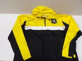 a yellow and black jacket sitting on top of a white table