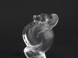 a clear glass figurine of a bear on a black background