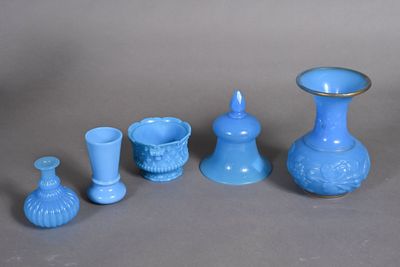 several pieces of blue glass sitting on top of a gray surface