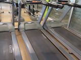row of treads in a gym room with windows and a television
