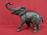 statue of an elephant on a red background with a red backdrop