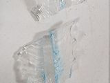 a glass sculpture made to look like a flower on the wall