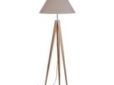 a wooden floor lamp with a white shade on top of it