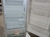 an open refrigerator that is sitting in a room