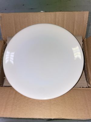 une assiette blanche dans une boîte en carton posée sur une table