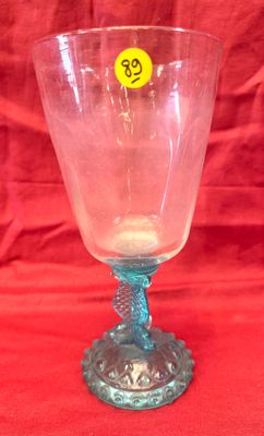 a glass with a yellow sticker on it on a red background