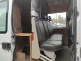 a white van with black seats and a table in the back