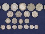 an image of a group of silver coins on a blue cloth