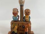 a figurine of two people sitting on a bench
