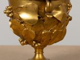 a gold vase with a heart on it on a table