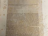an old book with writing on it sitting on a table