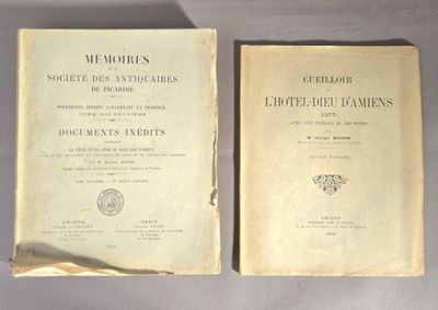 un vieux livre posé sur une table à côté d'un autre livre