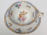 a cup and saucer sitting on top of a saucer