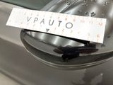 a sticker on the side mirror of a silver car
