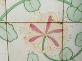 a picture of a tiled wall with flowers on it