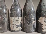 four bottles of wine are lined up on a table