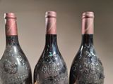 three bottles of wine that are sitting on a table