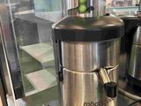 a silver and black juicer sitting on top of a counter