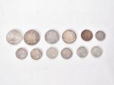 a lot of coins that are on a white surface