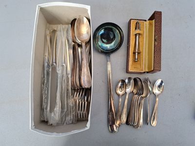 a lot of silverware in a box on the table