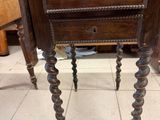 a small wooden table with a drawer on top of it