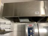 a large stainless steel oven in a kitchen with white tiles on the walls