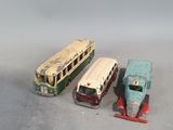 three toy buses sitting next to each other on a table