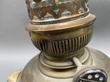 a metal lamp with a glass on top of it