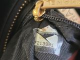 a close up of a purse with a tag on it