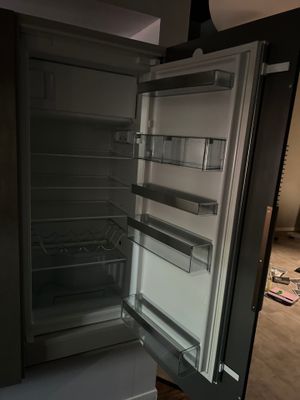 an open refrigerator that is sitting in a room