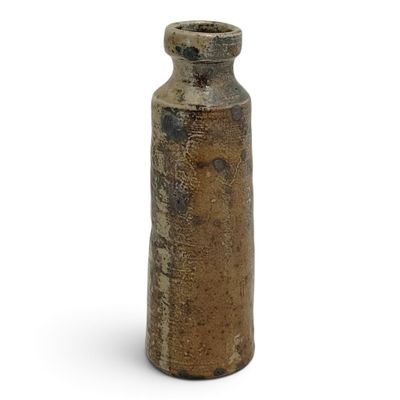 a brown vase that is sitting on a white surface
