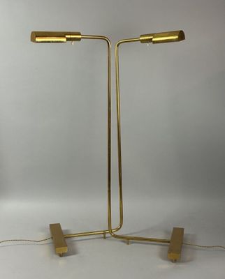 a pair of brass floor lamps on a white background