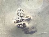 a close up of a silver plate with a logo on it