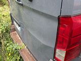 a van that has been vandalized and is parked in the grass
