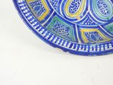 a blue and yellow plate with a design on it
