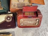 several old fashioned radio ' s are sitting on the floor next to each other
