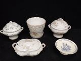 many different types of porcelain dishes and bowls on the table