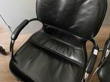 pair of black leather office chairs on wooden floor in room