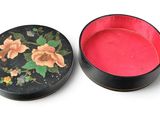 an image of a black and red box with flowers on it